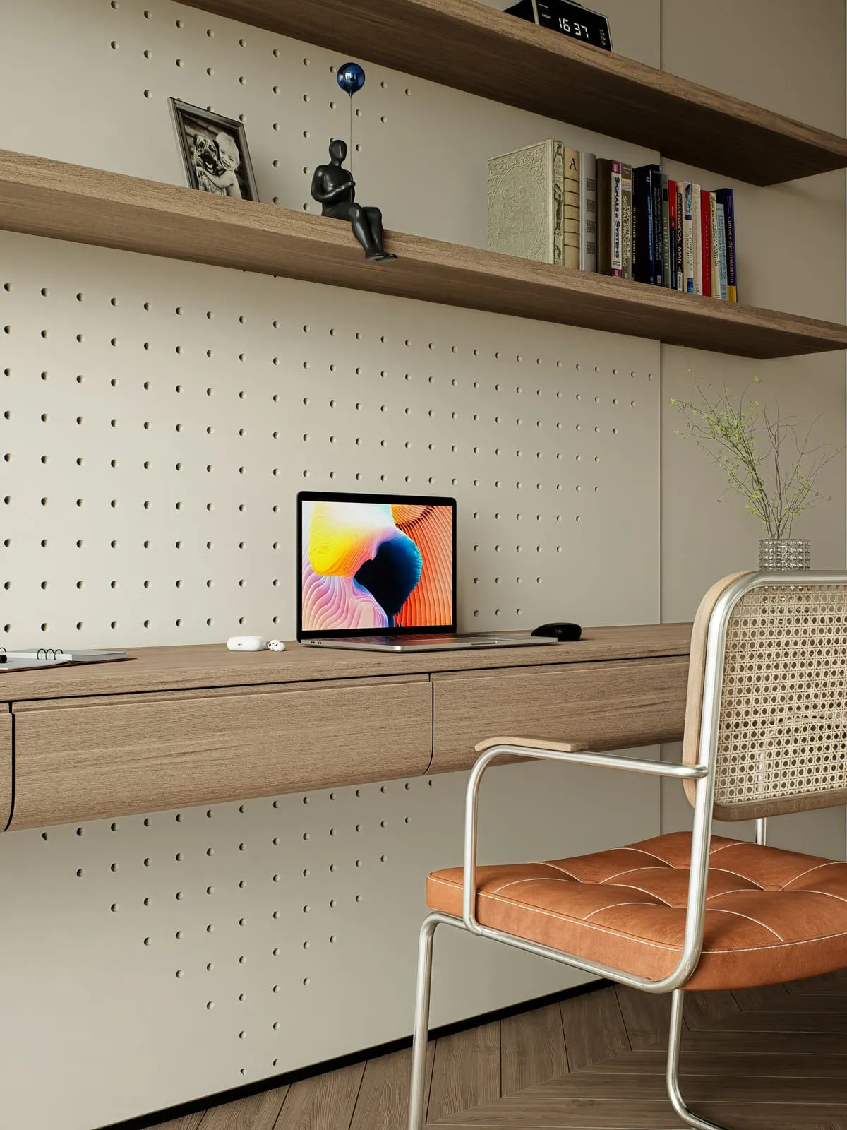 A desk with a laptop in a bright studio
