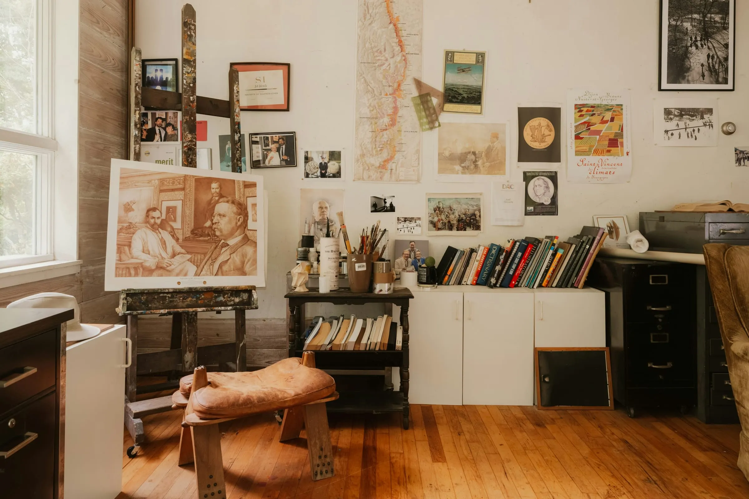 An artist's studio with paintings on the walls